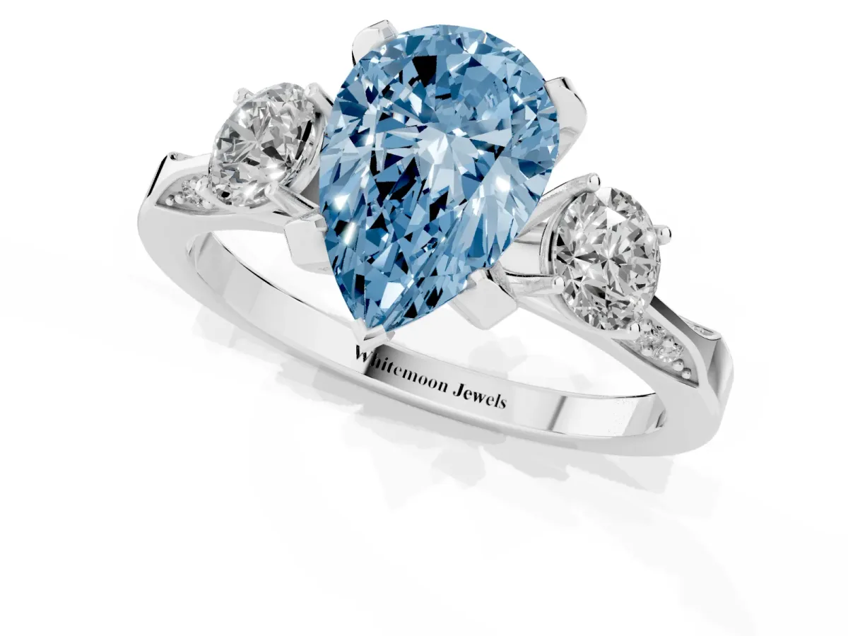 Fancy Blue Pear Cut Brilliant Three-Stone Diamond Ring with Pavé Band and Four-Prong Setting Silver