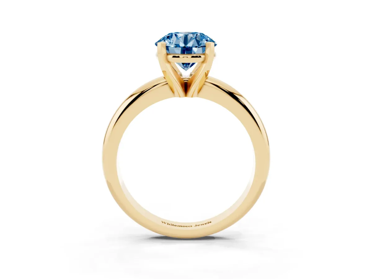 Fancy Blue Round Cut Diamond Solitaire Engagement Ring with Round Band and Four-Prong Setting Yellow gold
