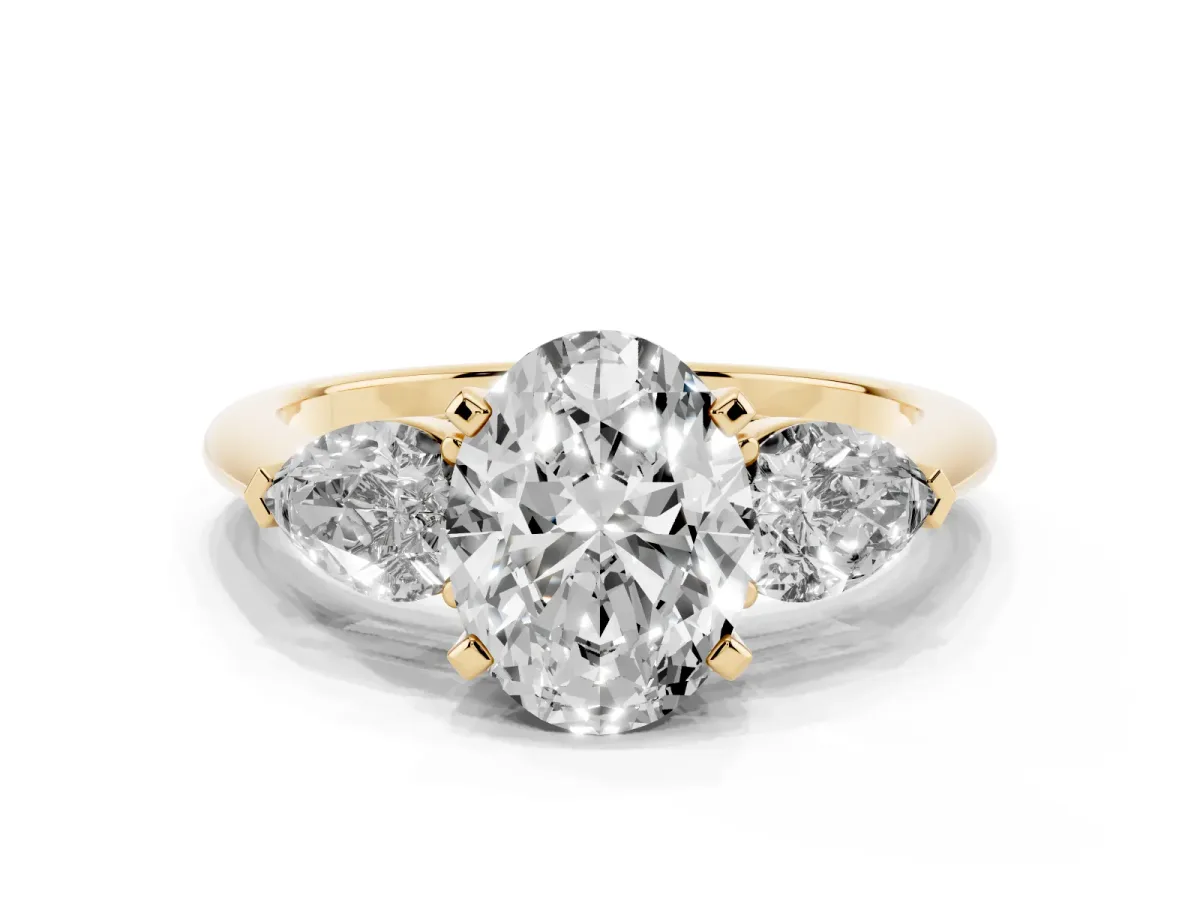 Three-Stone Oval Cut Diamond Ring with Pear Side Stones and Four-Prong Setting Yellow gold