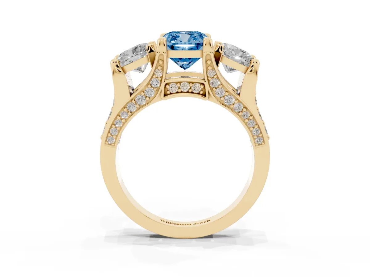 Fancy Blue Cushion Cut Diamond Three-Stone Ring with Channel Set Band and Four-Prong Setting Yellow gold