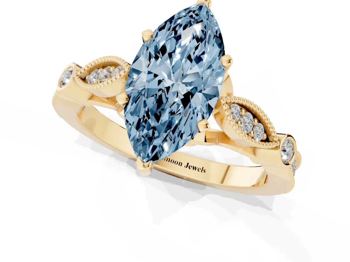 Fancy Blue Marquise Cut Cut Diamond with Milgrain Marquise and Bezel Accents on a Solitaire Band with Prong Setting Yellow gold