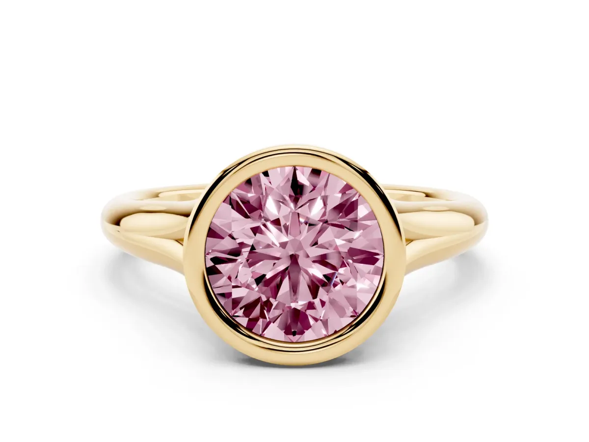 Fancy Pink Bezel Set Round Cut Solitaire Diamond Ring with Smooth Band Yellow gold