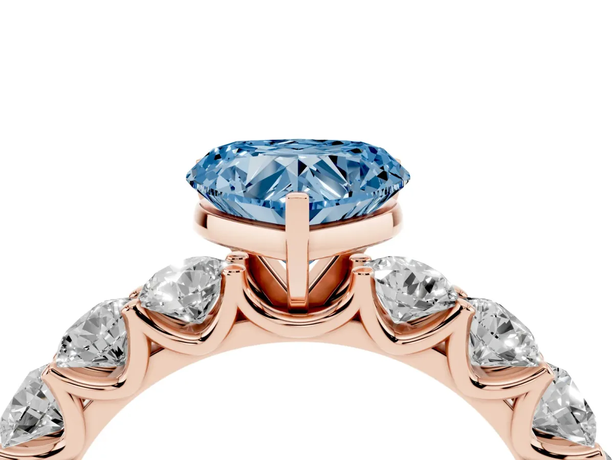 Fancy Blue Heart Cut Diamond Prong Setting with Side Stones on a Pave Band Rose gold