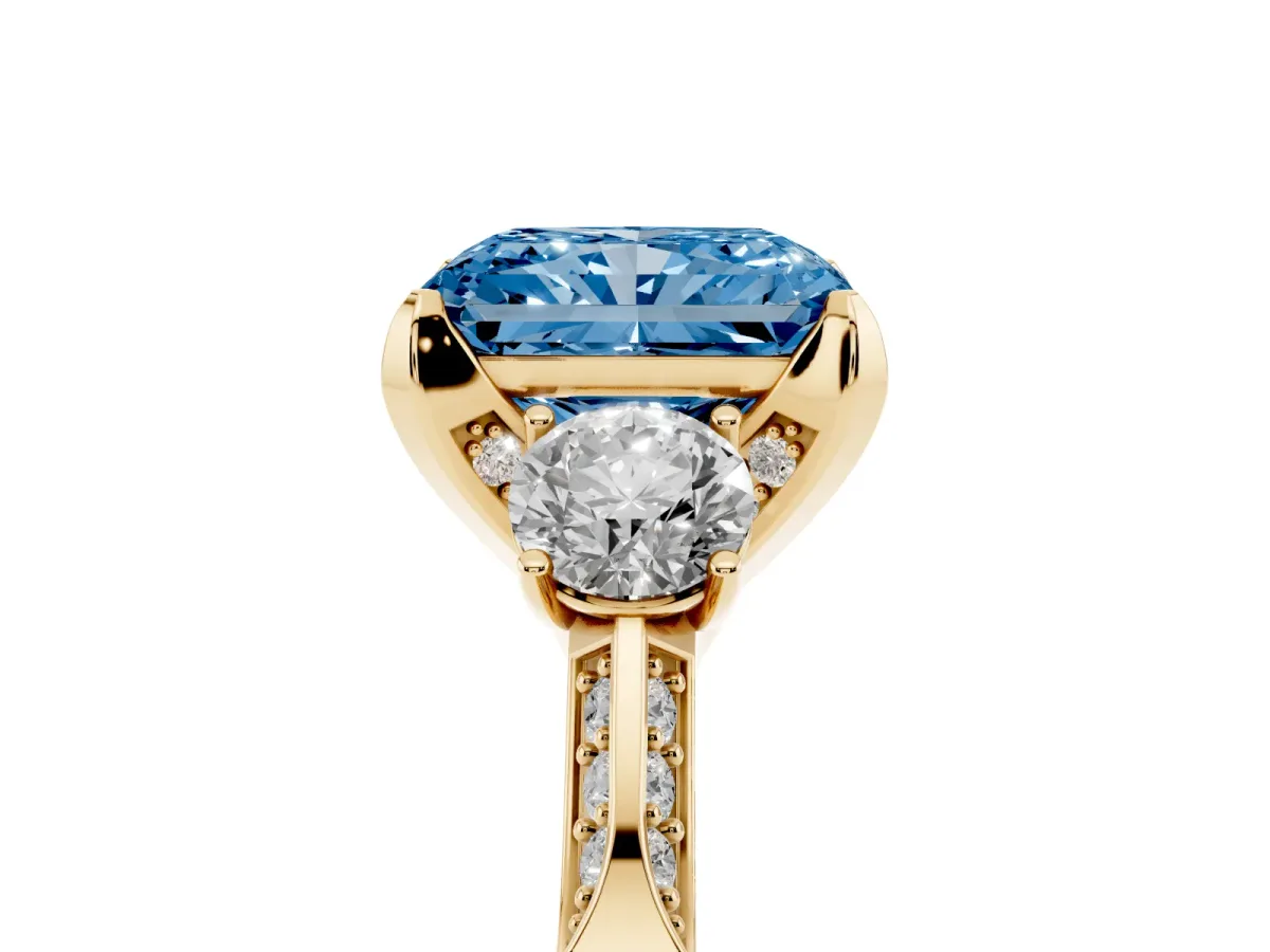 Fancy Blue Radiant Cut Brilliant Three-Stone Diamond Ring with Pavé Band and Four-Prong Setting Yellow gold