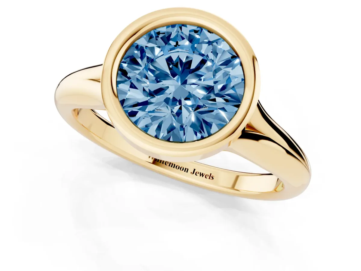 Fancy Blue Bezel Set Round Cut Solitaire Diamond Ring with Smooth Band Yellow gold