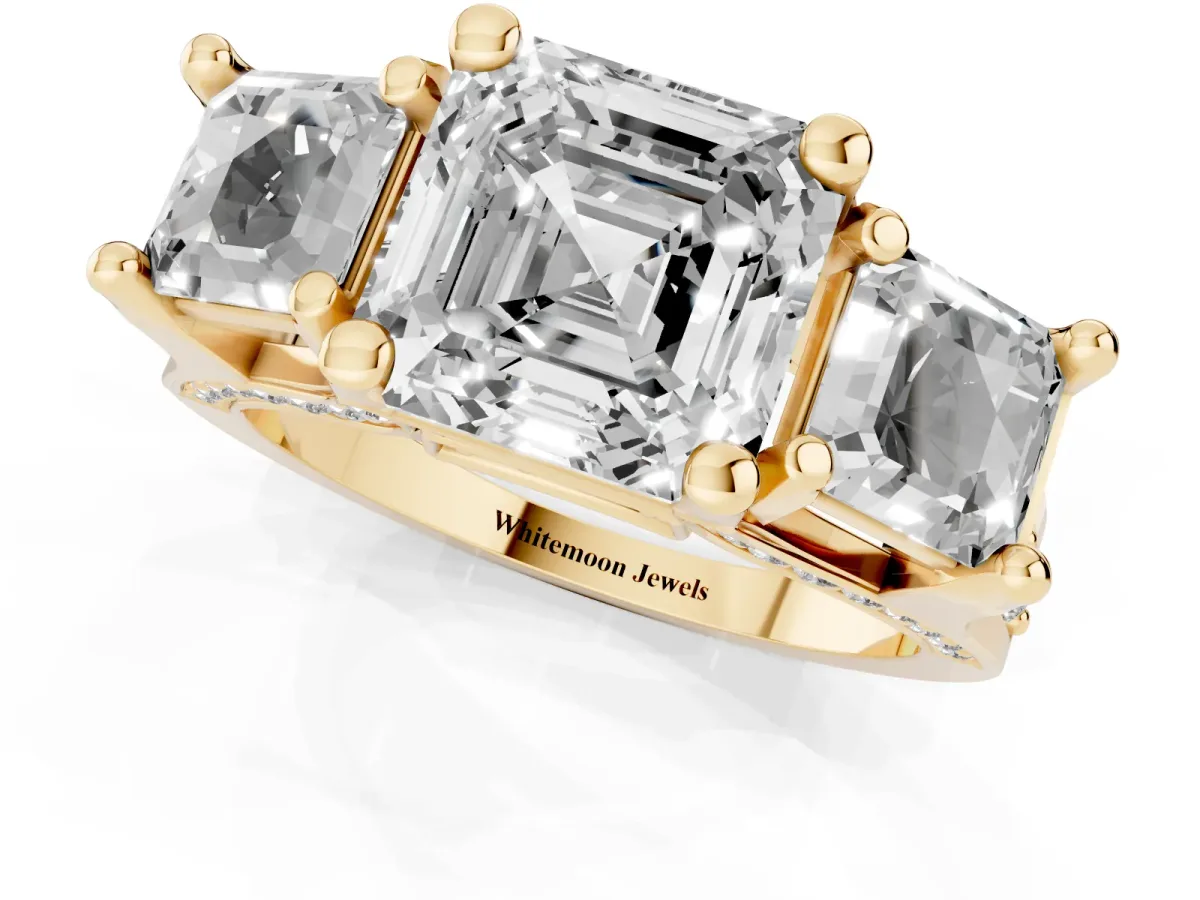 Asscher Cut Diamond Three-Stone Ring with Channel Set Band and Four-Prong Setting Yellow gold