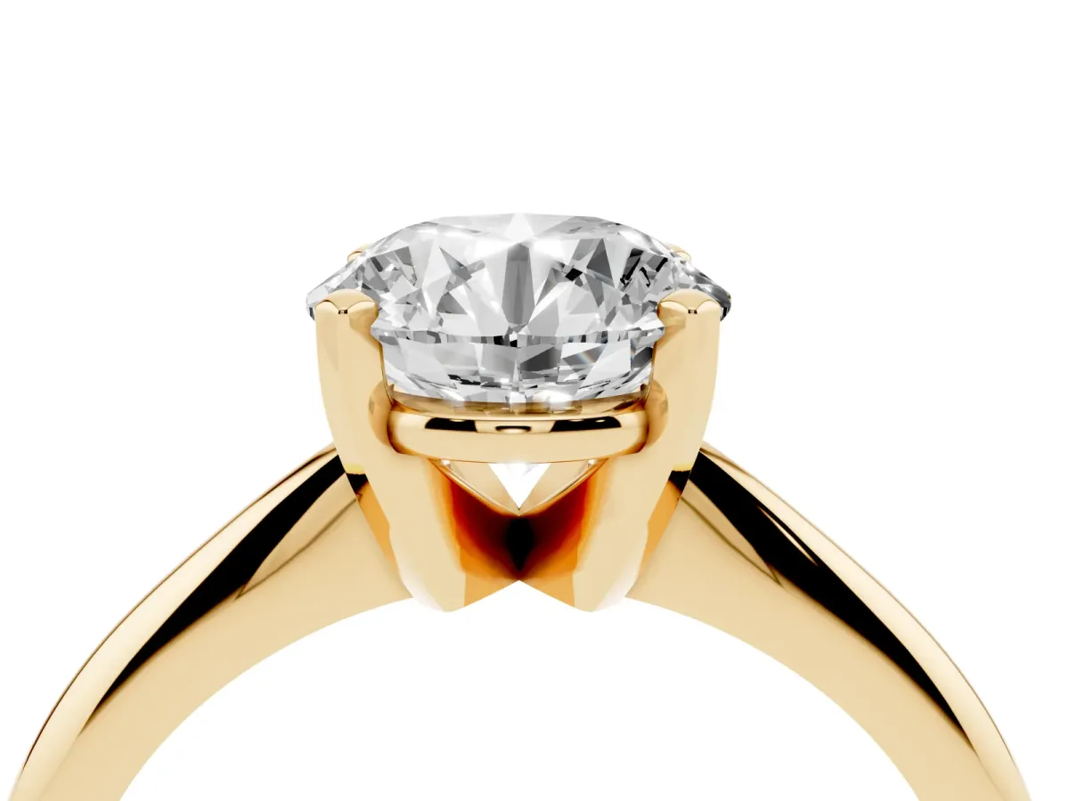Round Cut Cut Solitaire Ring with Four-Prong Setting on a Classic Band Yellow gold