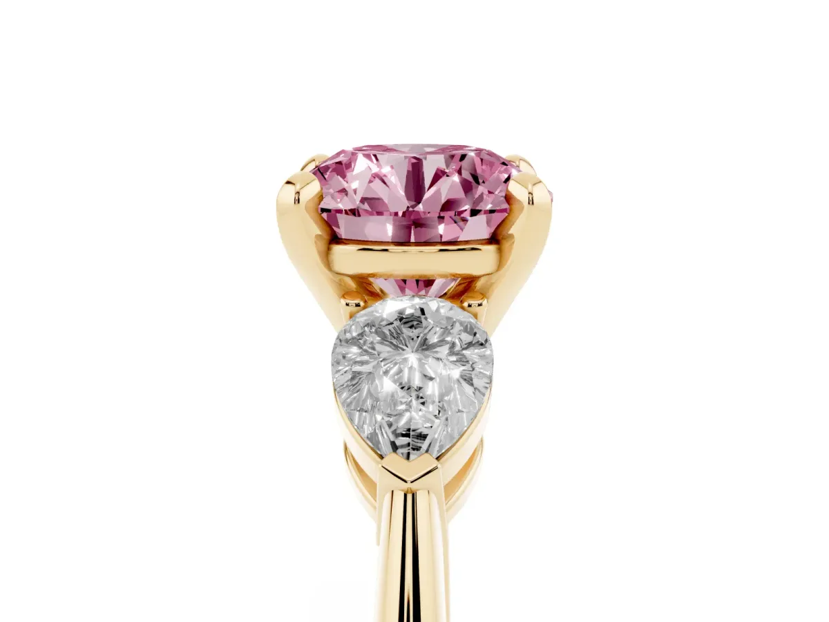 Fancy Pink Three-Stone Round Cut Diamond Ring with Pear Side Stones and Four-Prong Setting Yellow gold