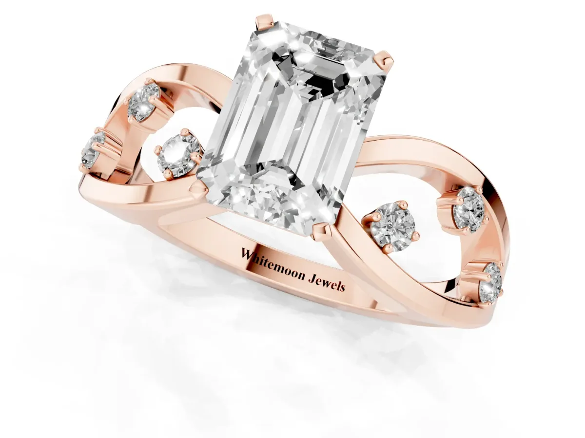 Emerald Cut Cut Solitaire Diamond with Side Stones on Criss-Cross Band and Four-Prong Setting Rose gold