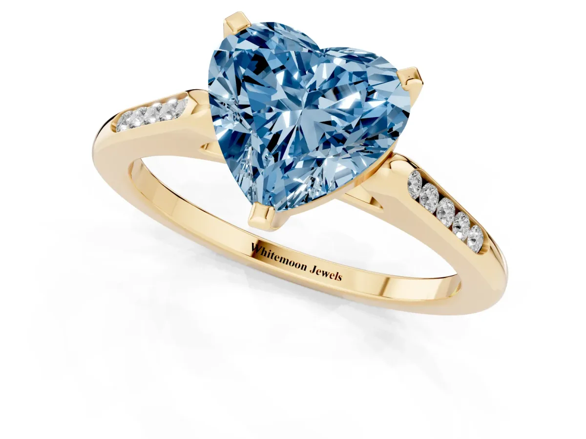 Fancy Blue Heart Cut Diamond Solitaire Ring with Channel Set Round Band and Prong Setting Yellow gold