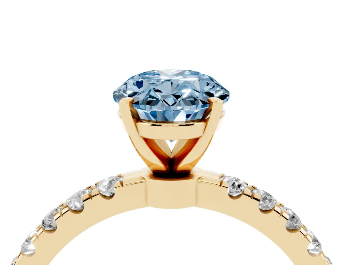 Fancy Blue Oval Cut Diamond Solitaire Ring with Pavé Accents and Four-Prong Setting Yellow gold