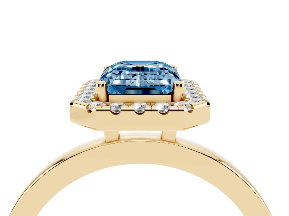 Fancy Blue Emerald Cut Halo Diamond Solitaire with Pavé Band and Four-Prong Setting Yellow gold