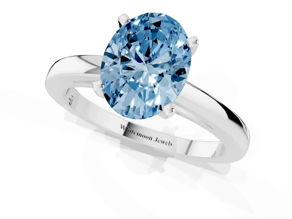 Fancy Blue Oval Cut Solitaire Diamond Engagement Ring with Four-Prong Setting on a Classic Band Silver