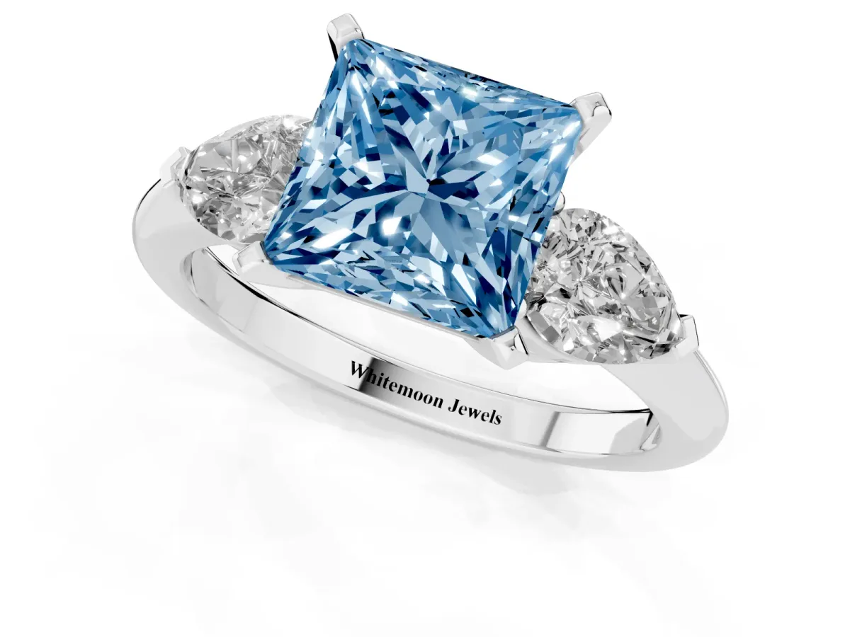 Fancy Blue Three-Stone Princess Cut Diamond Ring with Pear Side Stones and Four-Prong Setting Platinum