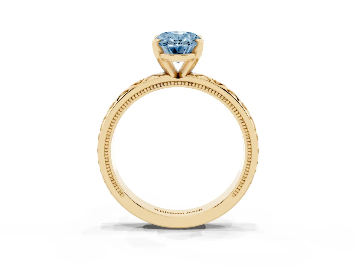 Fancy Blue Oval Cut Solitaire Diamond Engagement Ring with XO Engraved Band and Four-Prong Setting Yellow gold