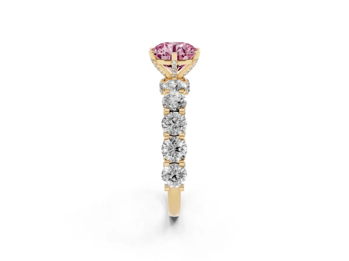 Fancy Pink Round Cut Diamond Side Stone Engagement Ring with Four-Prong Setting Yellow gold