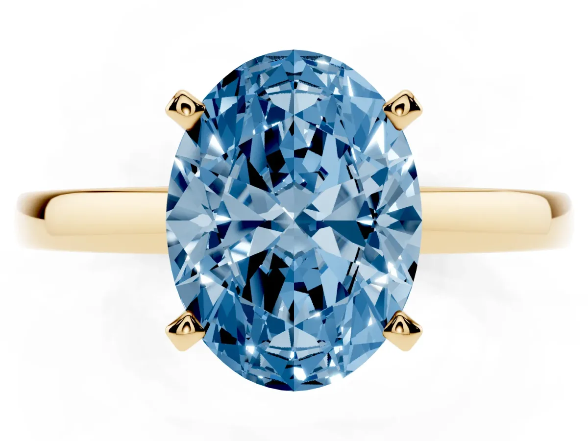 Fancy Blue Oval Cut Solitaire Diamond Engagement Ring with Four-Prong Setting on a Classic Band Yellow gold
