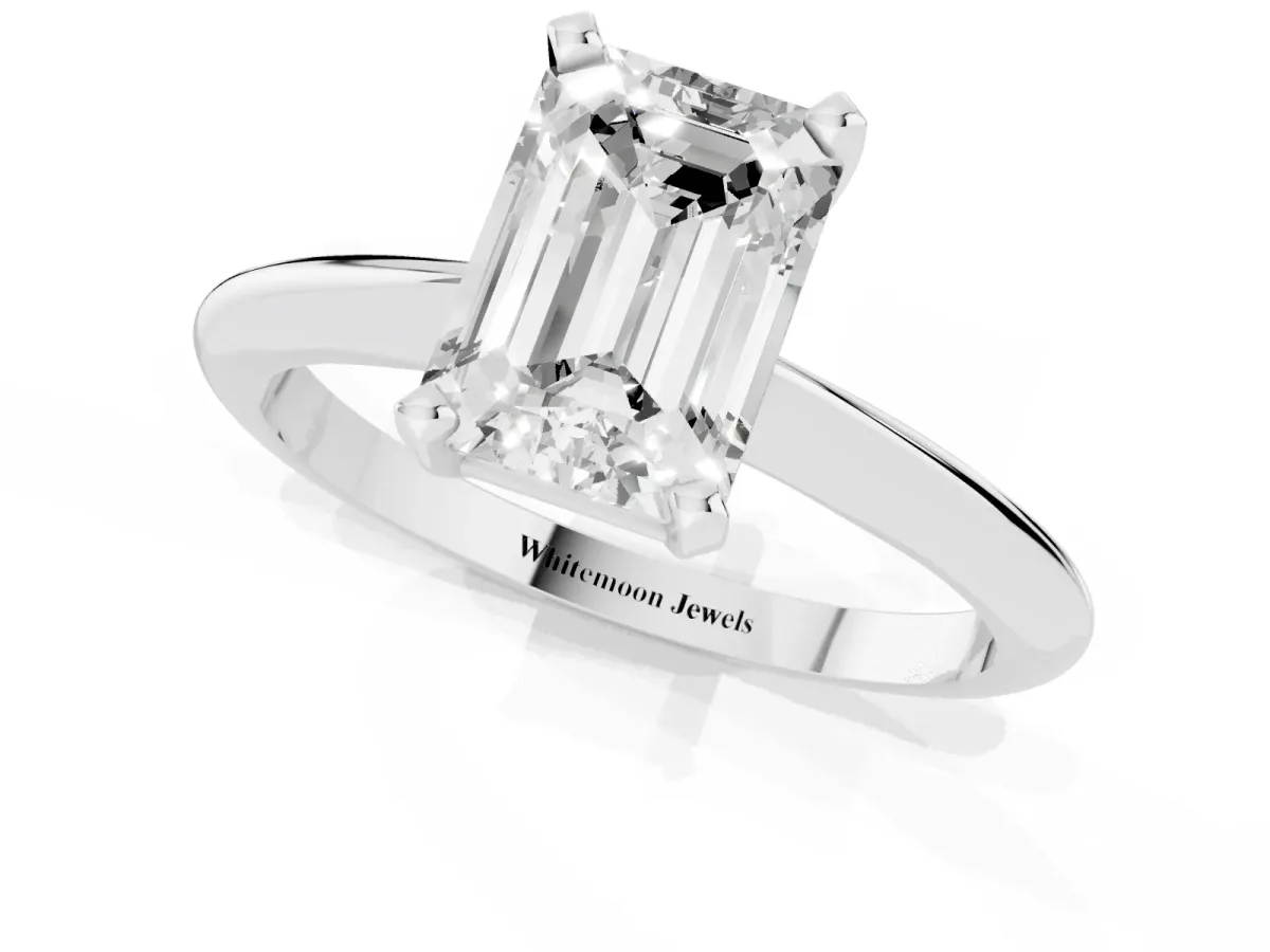 Emerald Cut Cut Solitaire Ring with Four-Prong Setting on a Classic Band Silver