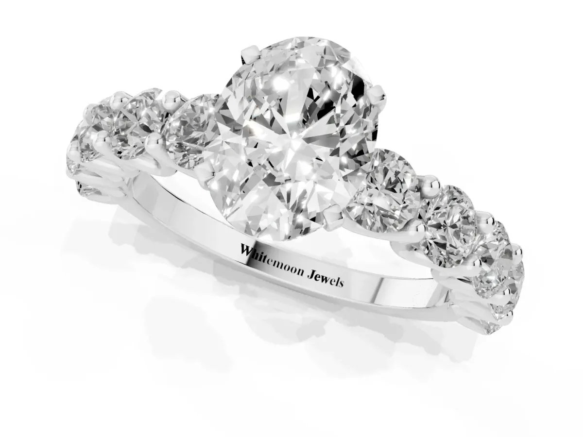 Oval Cut Diamond Prong Setting with Side Stones on a Pave Band Silver