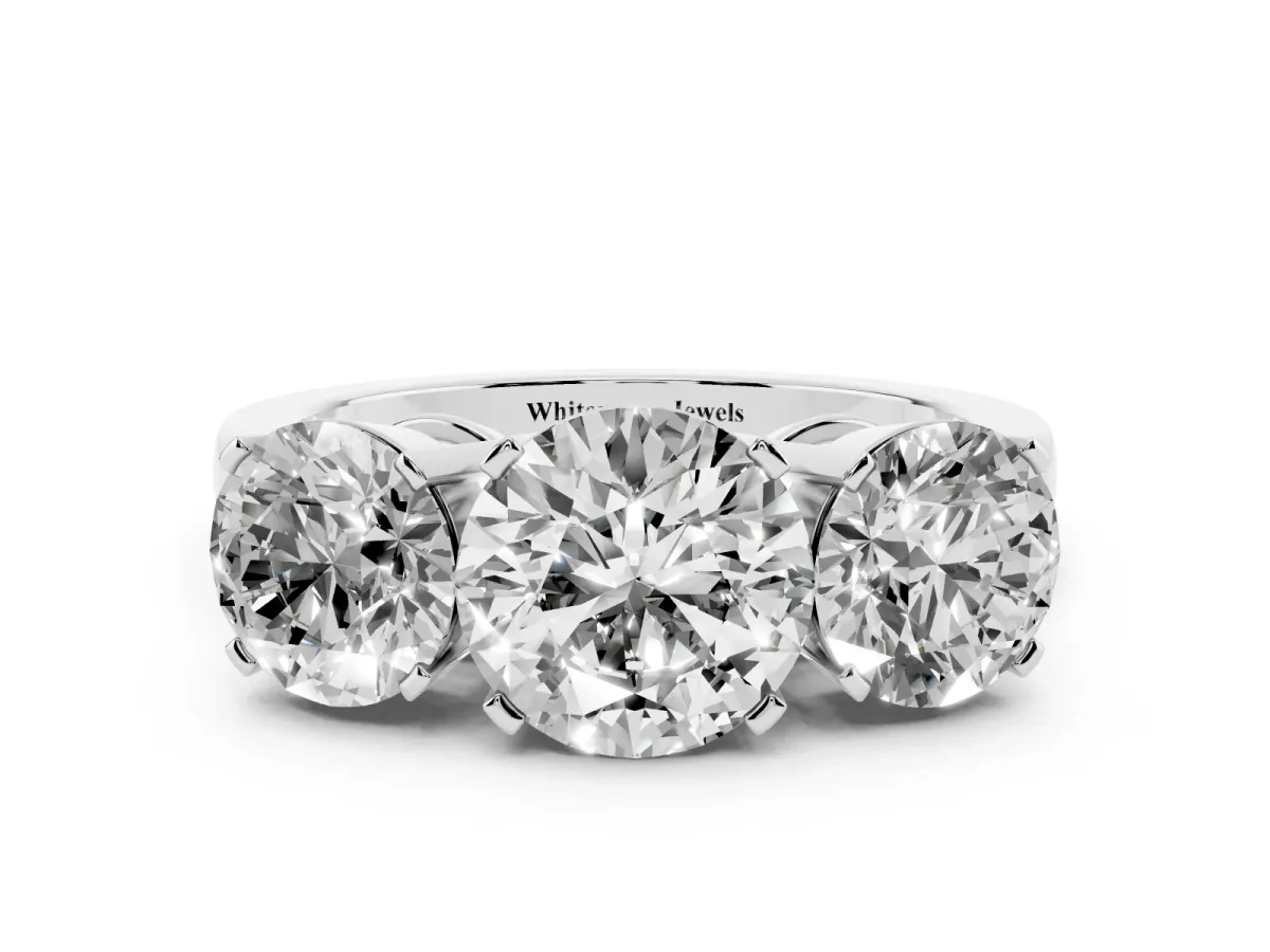 Three-Stone Round Cut Cut Diamond Ring with Channel Set Band and Four-Prong Setting Platinum