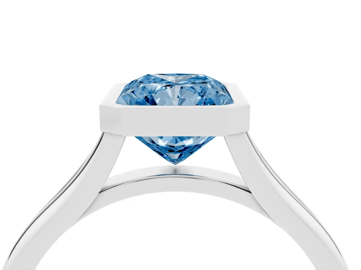 Fancy Blue Bezel Set Radiant Cut Cut Solitaire Ring with Tapered Band Silver