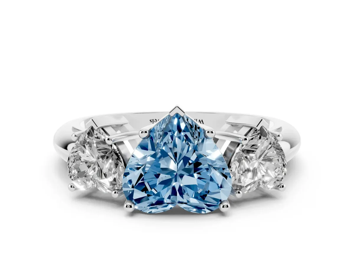 Fancy Blue Three-Stone Heart Cut Cut Diamond Engagement Ring with Prong Setting on a White Gold Band Platinum