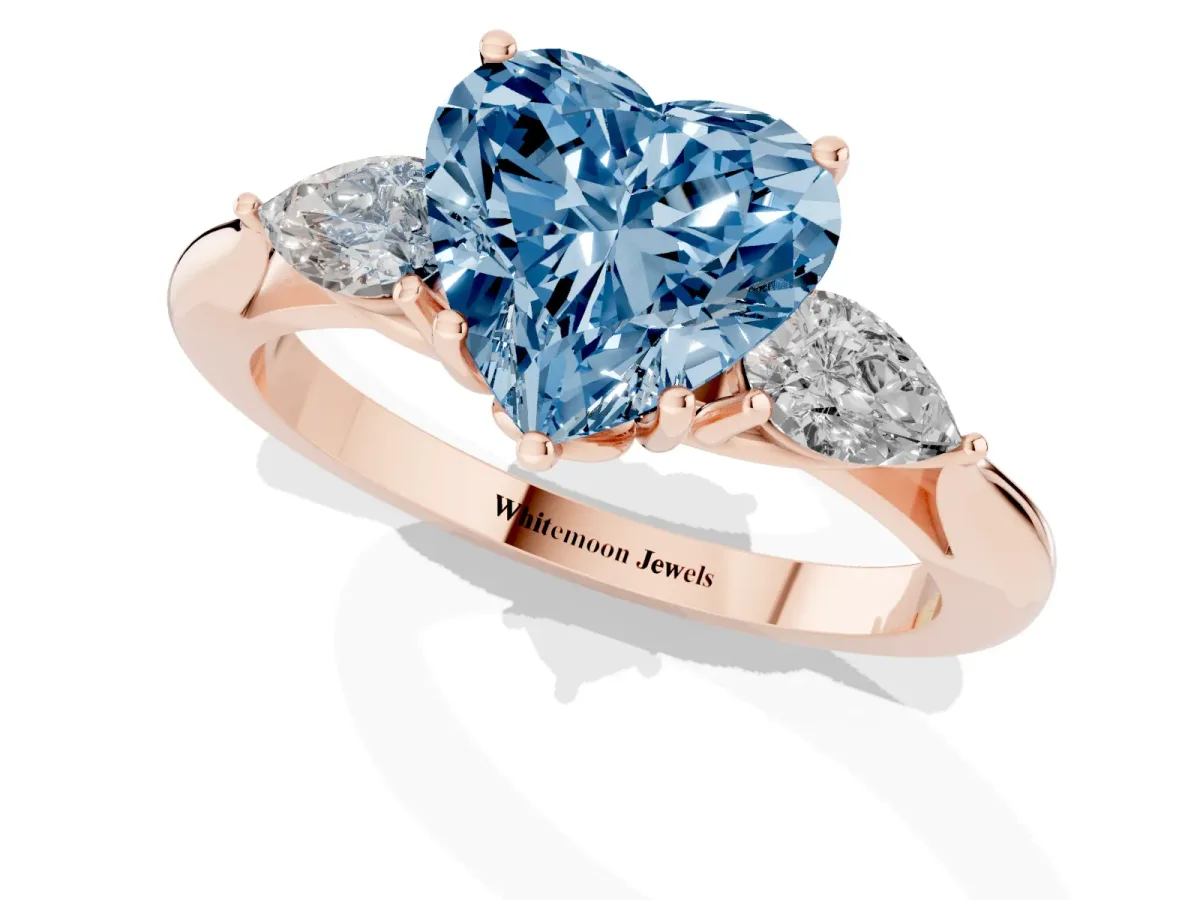 Fancy Blue Heart Cut Diamond Three-Stone Ring with Pear Side Stones and Prong Setting Rose gold