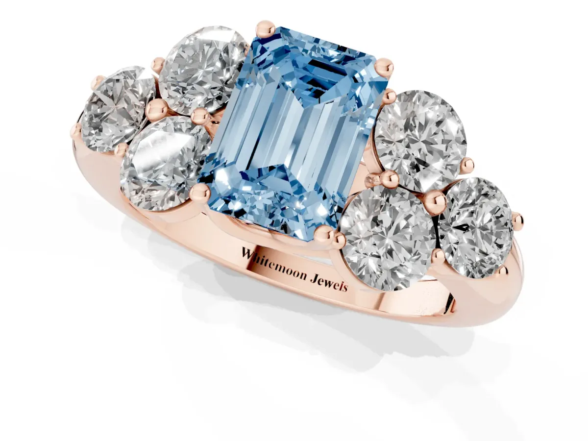 Fancy Blue Emerald Cut Cut Diamond Cluster Ring with Round Accent Stones and Prong Setting on a Classic Band Rose gold