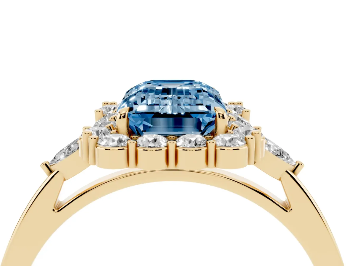 Fancy Blue Emerald Cut Diamond Halo Ring with Pear Side Stones and Prong Setting Yellow gold