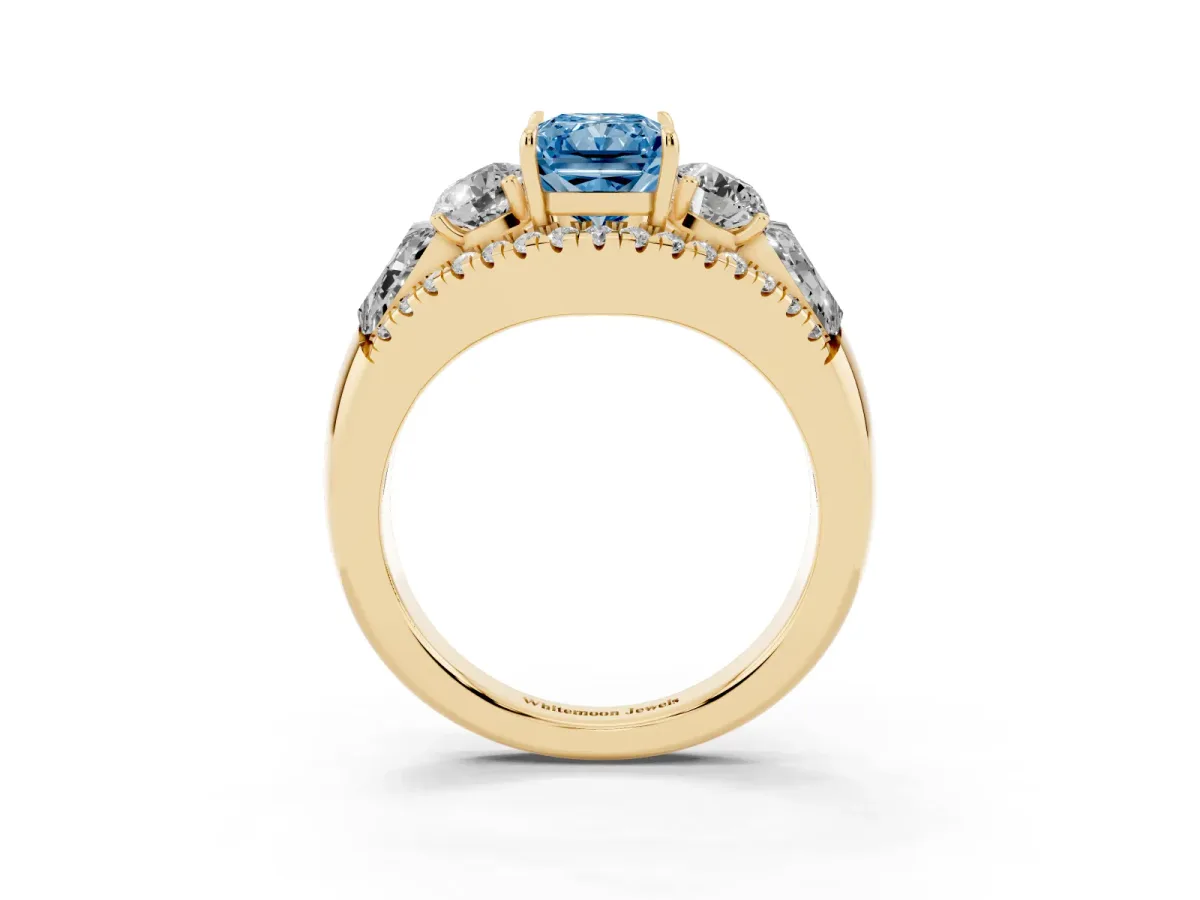 Fancy Blue Three-Stone Radiant Cut Diamond Engagement Ring with Pave Band and Prong Setting Yellow gold