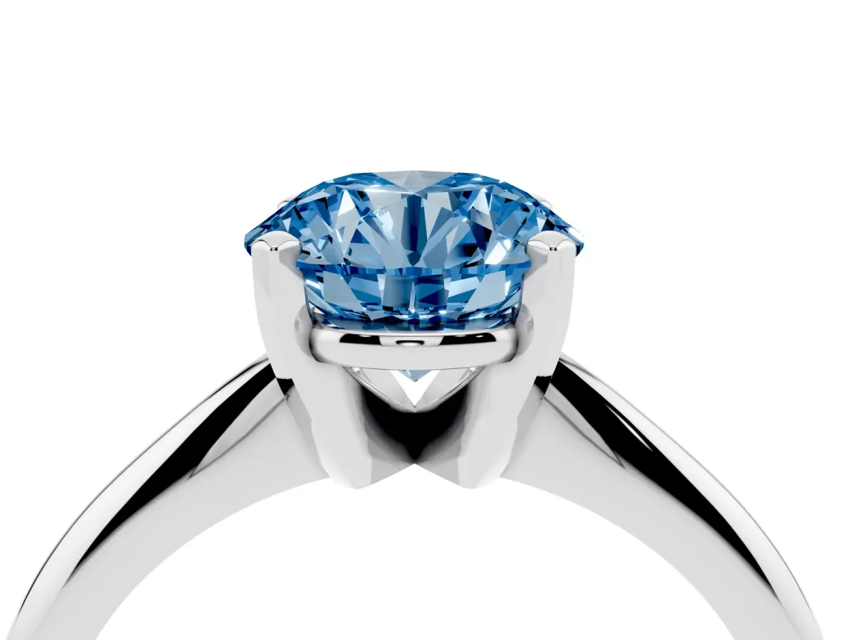 Fancy Blue Round Cut Cut Solitaire Ring with Four-Prong Setting on a Classic Band Silver