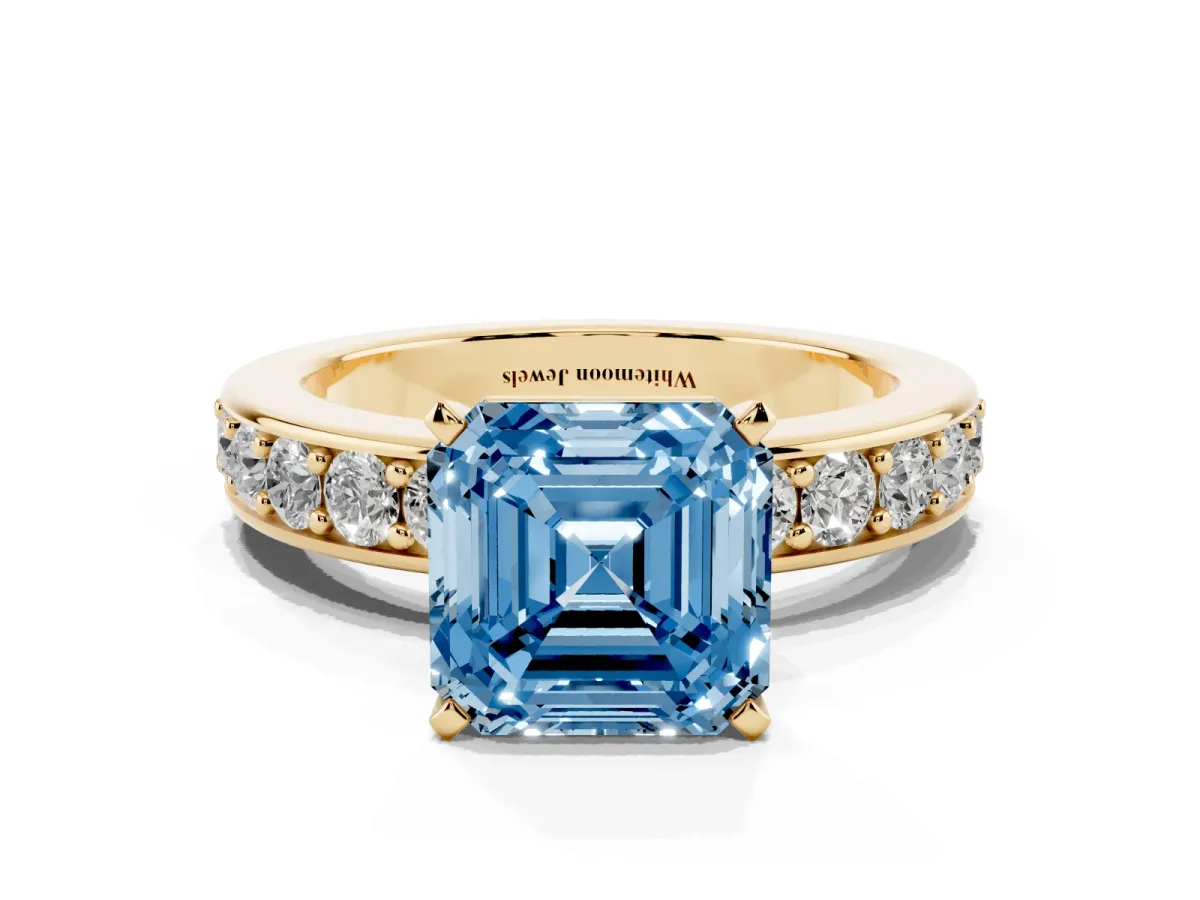 Fancy Blue Asscher Cut Diamond Engagement Ring with Channel Set Round Band and Prong Setting Yellow gold
