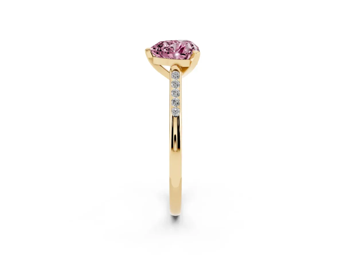 Fancy Pink Heart Cut Diamond Solitaire Ring with Channel Set Round Band and Prong Setting Yellow gold