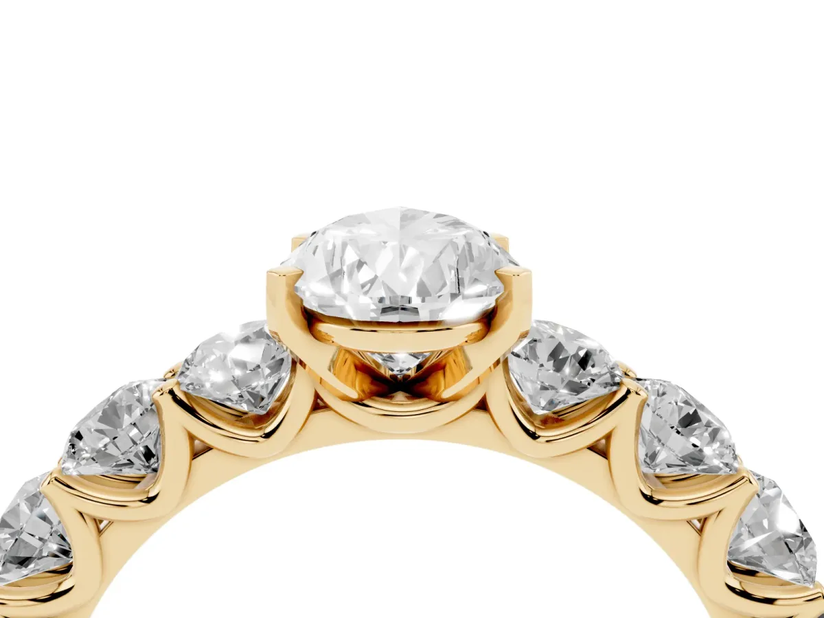 Pear Cut Diamond Prong Setting with Side Stones on a Pave Band Yellow gold