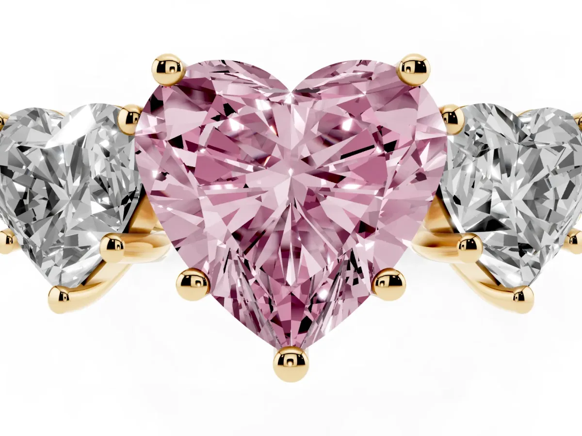 Fancy Pink Three-Stone Heart Cut Diamond Ring with Round Pavé Band and Prong Setting Yellow gold