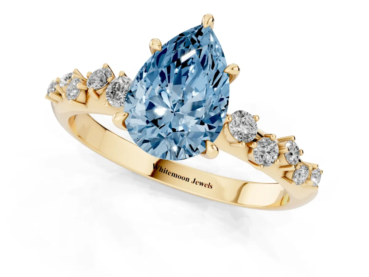Fancy Blue Pear Cut Diamond Cluster Side Stone Solitaire Ring with Prong Setting Yellow gold