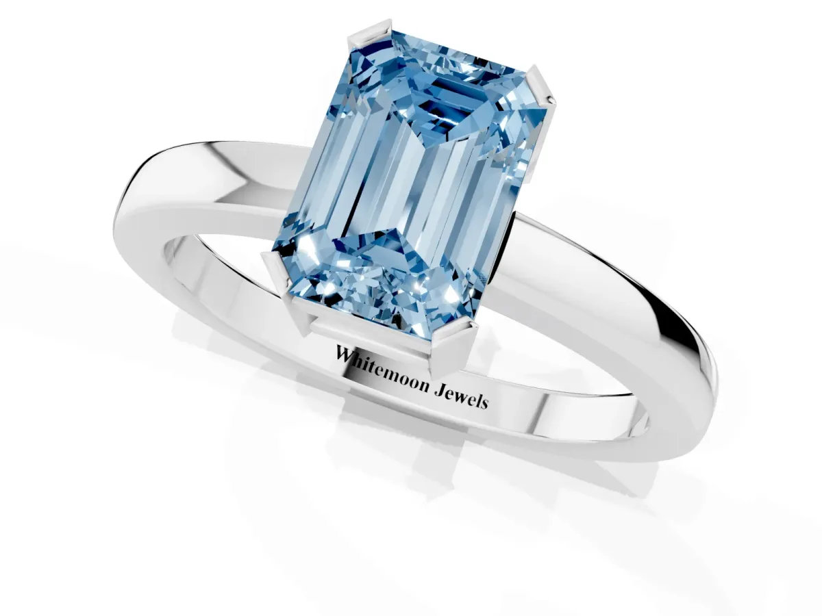 Fancy Blue Emerald Cut Cut Solitaire Ring with Four-Prong Setting and Classic Band Silver