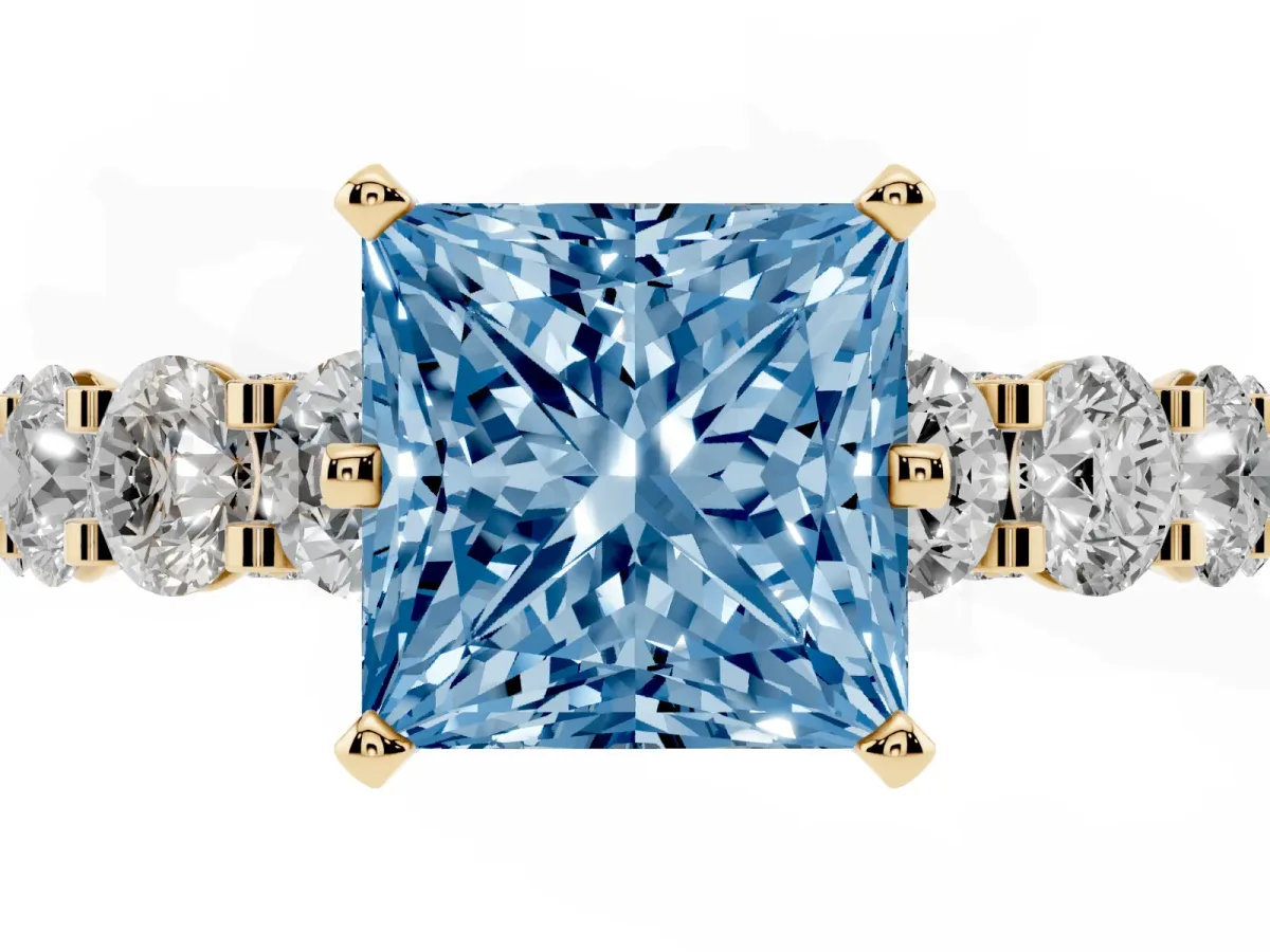Fancy Blue Princess Cut Diamond Side Stone Engagement Ring with Four-Prong Setting Yellow gold