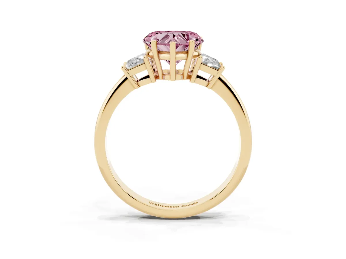 Fancy Pink Heart Cut Diamond Three-Stone Ring with Trapezoid Side Stones and Prong Setting Yellow gold