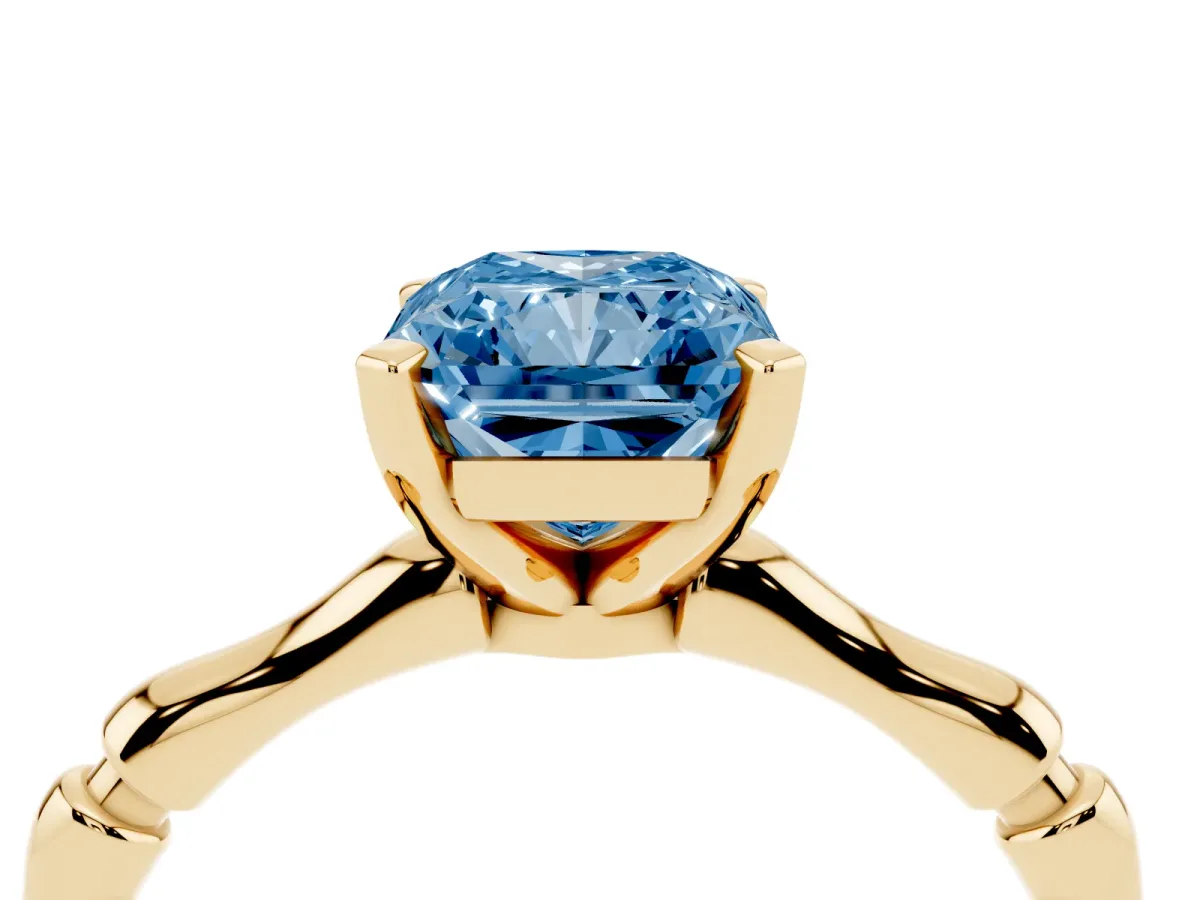 Fancy Blue Radiant Cut Solitaire Diamond Ring with Bamboo Band and Four-Prong Setting Yellow gold
