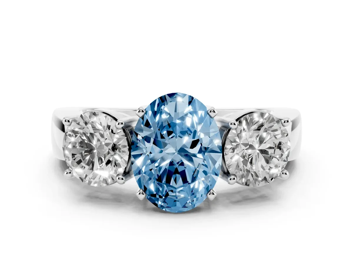 Fancy Blue Three-Stone Oval Cut Diamond Ring with Round Side Stones, Classic Band, and Four-Prong Setting White gold