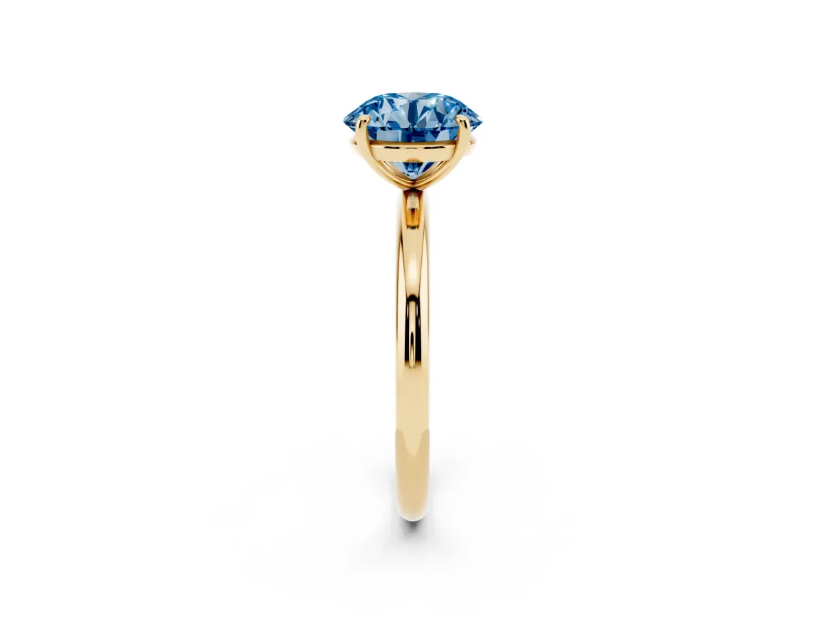Fancy Blue Round Cut Solitaire Diamond Ring with Four-Prong Setting on a Plain Band Yellow gold