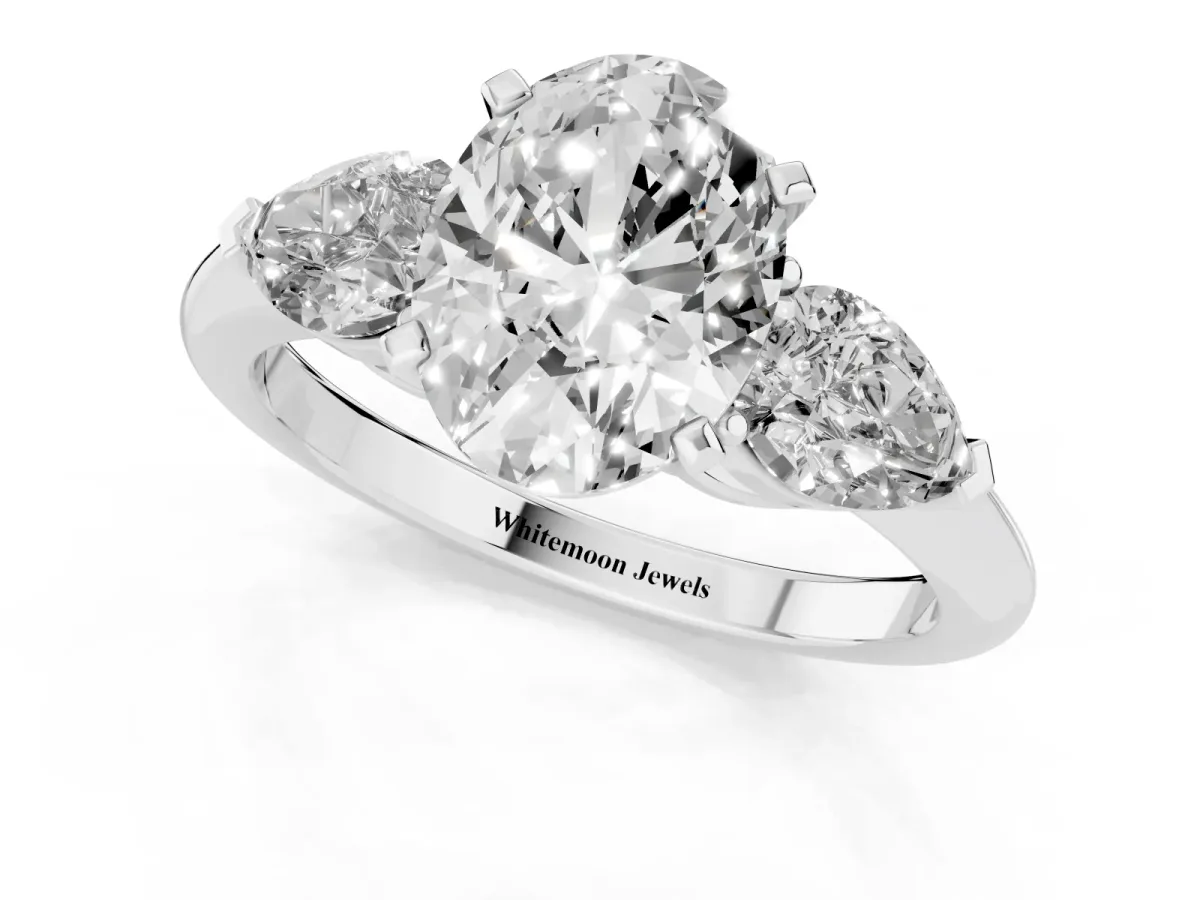 Three-Stone Oval Cut Diamond Ring with Pear Side Stones and Four-Prong Setting White gold