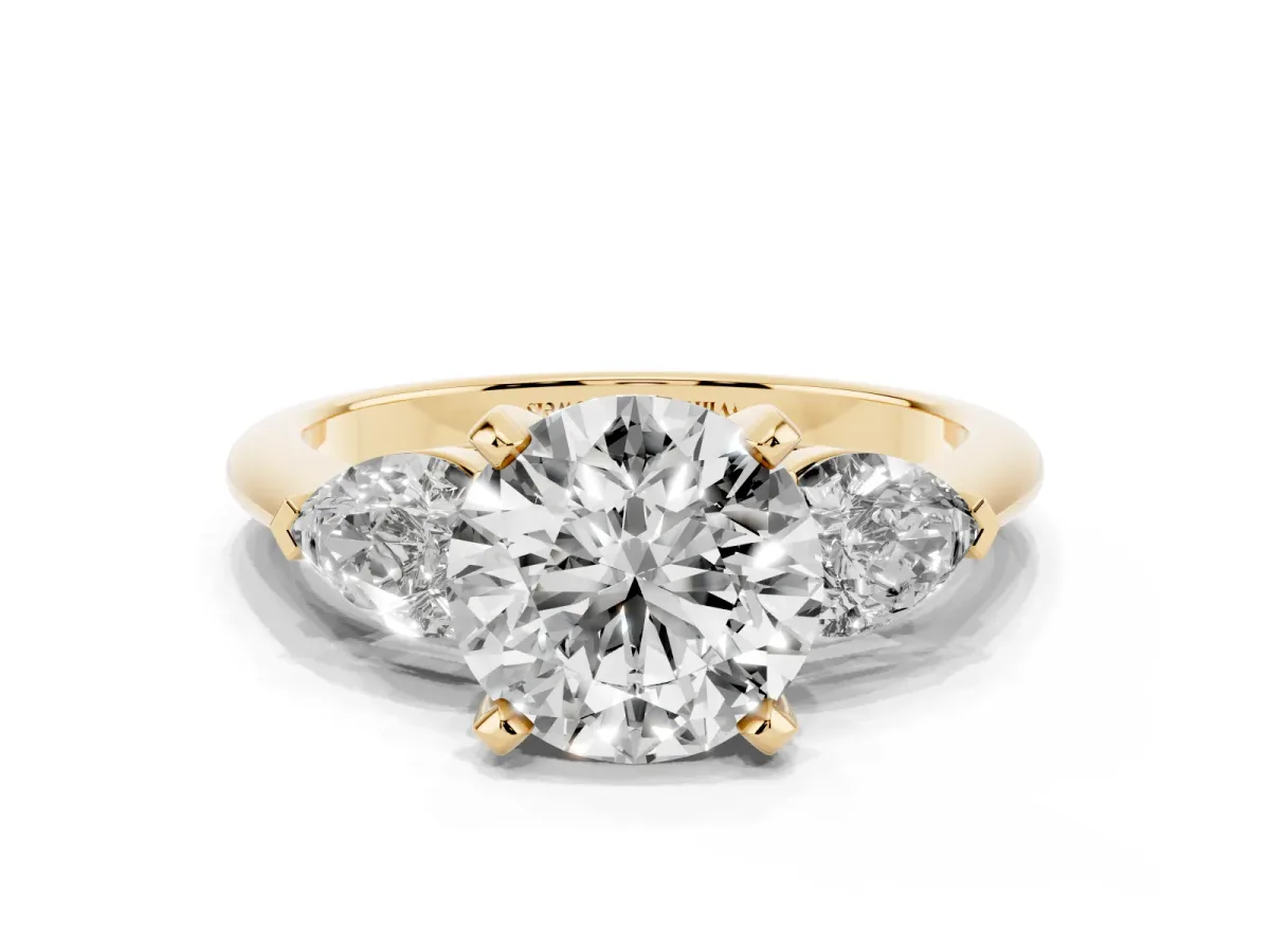 Three-Stone Round Cut Diamond Ring with Pear Side Stones and Four-Prong Setting Yellow gold