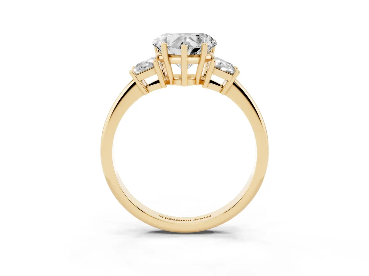 Heart Cut Diamond Three-Stone Ring with Trapezoid Side Stones and Prong Setting Yellow gold
