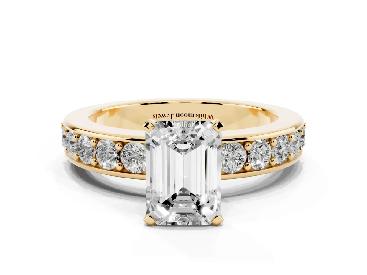 Emerald Cut Diamond Engagement Ring with Channel Set Round Band and Prong Setting Yellow gold