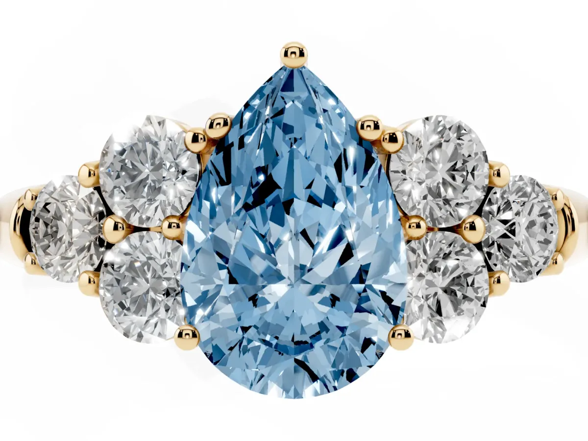 Fancy Blue Pear Cut Cut Diamond Cluster Ring with Round Accent Stones and Prong Setting on a Classic Band Yellow gold