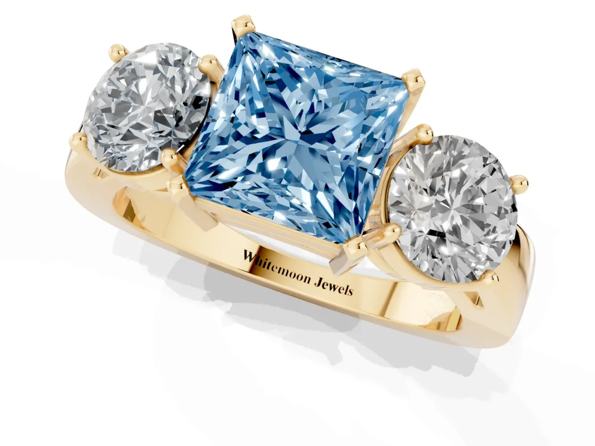 Fancy Blue Three-Stone Princess Cut Diamond Ring with Round Side Stones, Classic Band, and Four-Prong Setting Yellow gold