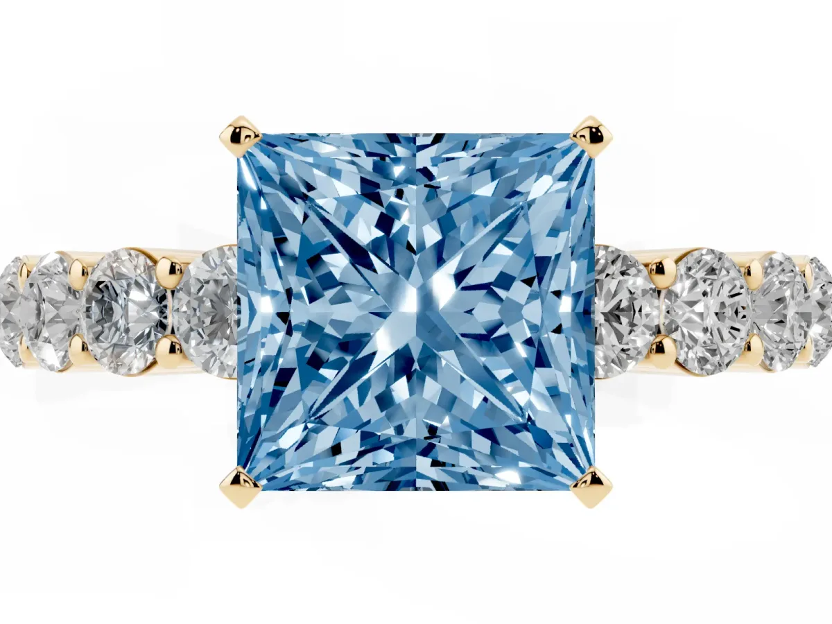 Fancy Blue Princess Cut Diamond Solitaire Ring with Shared Prong Round Side Stones Yellow gold
