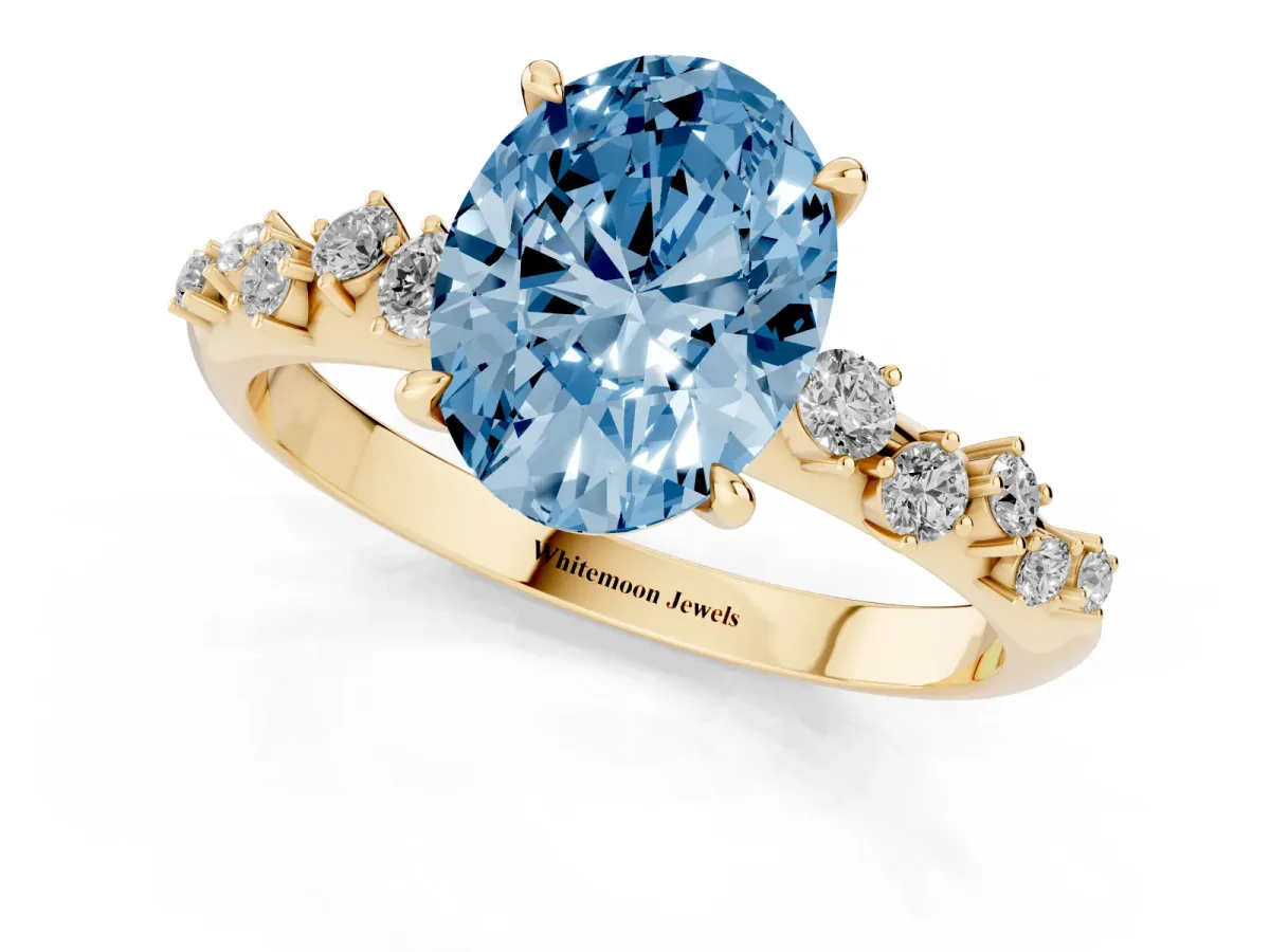 Fancy Blue Oval Cut Diamond Cluster Side Stone Solitaire Ring with Prong Setting Yellow gold